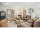 Comfortable living room with large sectional sofa, stylish decor, and hardwood floors for a warm welcome at 6930 Wesley Hughes Rd, Cumming, GA 30040