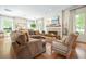 Spacious living room with a fireplace, comfortable seating, and hardwood floors for a cozy atmosphere at 6930 Wesley Hughes Rd, Cumming, GA 30040