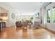 Open-concept living room with hardwood floors, fireplace, and large windows, great for entertaining guests at 6930 Wesley Hughes Rd, Cumming, GA 30040