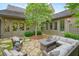 Secluded outdoor patio featuring wicker furniture, stone floor, and meticulous landscaping at 6930 Wesley Hughes Rd, Cumming, GA 30040
