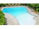 Aerial view of a community pool featuring a shallow end, with ample deck space for lounging and recreation at 6930 Wesley Hughes Rd, Cumming, GA 30040