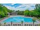 Community pool offers a refreshing escape with plenty of lounge chairs for relaxing by the water at 6930 Wesley Hughes Rd, Cumming, GA 30040
