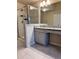 Modern bathroom featuring tiled flooring, a walk-in shower, and a granite countertop at 7703 Hansel Ln, Lithonia, GA 30058