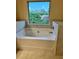 View of bathtub with a large window looking out to a natural setting at 7703 Hansel Ln, Lithonia, GA 30058