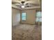 Spacious bedroom features a ceiling fan, tray ceiling, natural light, and neutral colors at 7703 Hansel Ln, Lithonia, GA 30058