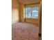 Bedroom featuring carpeted flooring, neutral walls, and a large window at 7703 Hansel Ln, Lithonia, GA 30058