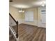 Elegant dining room with dark wood floors, chair rail moulding, and decorative lighting at 7703 Hansel Ln, Lithonia, GA 30058