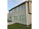 Home exterior featuring vinyl siding, a sliding glass door, and a concrete patio at 7703 Hansel Ln, Lithonia, GA 30058