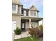 Inviting front entrance with a stone-accented facade, black front door, and manicured shrubs at 7703 Hansel Ln, Lithonia, GA 30058