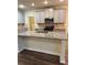 Spacious kitchen with ample counter space, stainless steel appliances, and grey cabinetry at 7703 Hansel Ln, Lithonia, GA 30058