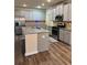 Well-equipped kitchen featuring stainless steel appliances, granite countertops, and a large island at 7703 Hansel Ln, Lithonia, GA 30058