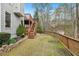 Expansive backyard with a wooden fence, lush greenery, and a glimpse of the surrounding natural beauty at 3887 Hickory Manor Dr, Suwanee, GA 30024
