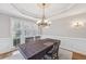 Bright dining room with a traditional table, decorative lighting, and large windows offering natural light at 3887 Hickory Manor Dr, Suwanee, GA 30024