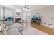 Cozy living room featuring hardwood floors, a fireplace, and large windows for natural light at 3887 Hickory Manor Dr, Suwanee, GA 30024