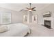 Bright main bedroom with fireplace, vaulted ceiling, ceiling fan, and adjacent Primary bath at 3887 Hickory Manor Dr, Suwanee, GA 30024