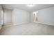 A large, carpeted bedroom with neutral colored walls and natural lighting at 5590 Bright Cross Way, Suwanee, GA 30024