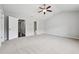 Bright, spacious bedroom with a ceiling fan, neutral carpet, and an ensuite bathroom at 5590 Bright Cross Way, Suwanee, GA 30024