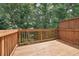 A wooden deck area overlooking lush, green trees and vegetation at 5590 Bright Cross Way, Suwanee, GA 30024