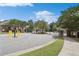 Gated neighborhood entrance with mature trees and green landscaping at 5590 Bright Cross Way, Suwanee, GA 30024