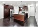 Modern kitchen with stainless steel appliances, granite countertops, and dark wood cabinetry at 5590 Bright Cross Way, Suwanee, GA 30024