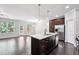 Open concept kitchen with granite counters, a center island, and stainless steel appliances at 5590 Bright Cross Way, Suwanee, GA 30024