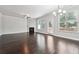 Spacious living room with hardwood floors, a fireplace, and plenty of natural light at 5590 Bright Cross Way, Suwanee, GA 30024