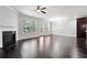 Bright living room featuring hardwood floors, a fireplace, and a ceiling fan at 5590 Bright Cross Way, Suwanee, GA 30024