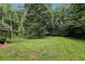 Expansive, green backyard with mature trees, providing a private, serene setting at 73 Azalea Dr, Villa Rica, GA 30180
