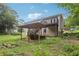 A home's backyard featuring a deck, covered area, and lush green lawn at 73 Azalea Dr, Villa Rica, GA 30180
