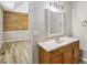 Bathroom featuring a marble countertop, wood vanity, mirror and adjacent room at 73 Azalea Dr, Villa Rica, GA 30180