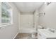 Updated bathroom featuring a window, shower-tub combo, sink and toilet at 73 Azalea Dr, Villa Rica, GA 30180