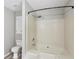 Bright bathroom featuring a shower and tub combination with tile surround at 73 Azalea Dr, Villa Rica, GA 30180