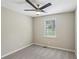 Cozy bedroom with neutral carpet, ceiling fan, and a bright window at 73 Azalea Dr, Villa Rica, GA 30180
