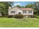 Charming split-level home featuring a well-manicured lawn, traditional siding, and decorative shutters at 73 Azalea Dr, Villa Rica, GA 30180