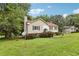 Charming split-level home featuring a well-manicured lawn, traditional siding, and decorative shutters at 73 Azalea Dr, Villa Rica, GA 30180