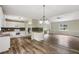 Open-concept kitchen with white cabinets, black backsplash, stainless steel appliances, and hardwood flooring at 73 Azalea Dr, Villa Rica, GA 30180