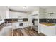 Bright kitchen features white cabinets, stainless steel appliances, and dark backsplash at 73 Azalea Dr, Villa Rica, GA 30180