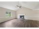 Spacious living room with a cozy fireplace, high ceilings, modern ceiling fan and stylish flooring at 73 Azalea Dr, Villa Rica, GA 30180