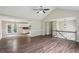 Open-concept living area with hardwood floors, neutral walls, staircase and seamless flow to the kitchen at 73 Azalea Dr, Villa Rica, GA 30180