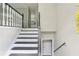 A neutral-toned staircase with white railings and dark trim adds a touch of elegance at 73 Azalea Dr, Villa Rica, GA 30180