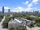 An aerial view shows the community in the city with an expansive skyline in the background at 133 City View Ne Ct, Atlanta, GA 30308