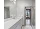 Modern bathroom featuring a long vanity with quartz countertop and large mirror at 133 City View Ne Ct, Atlanta, GA 30308
