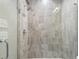 Walk-in shower featuring gray tile and a glass door at 133 City View Ne Ct, Atlanta, GA 30308