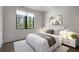 Bright bedroom features a comfortable bed, large window, and modern decor creating a cozy, inviting space at 133 City View Ne Ct, Atlanta, GA 30308