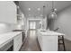 Modern kitchen featuring white cabinets, stainless steel appliances, and an island with pendant lighting at 133 City View Ne Ct, Atlanta, GA 30308