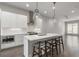 Bright kitchen with a quartz island, stainless steel oven, and pendant lighting flowing into the living space at 133 City View Ne Ct, Atlanta, GA 30308