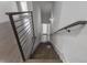 A sleek staircase with modern black metal railing and gray-stained steps leading downwards at 133 City View Ne Ct, Atlanta, GA 30308
