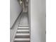 A clean and bright staircase with modern gray handrail and white walls leading upstairs at 133 City View Ne Ct, Atlanta, GA 30308