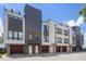 Modern townhomes showcase unique facade designs, including brick and gray elements, with individual garages at 133 City View Ne Ct, Atlanta, GA 30308