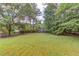 Expansive backyard with mature trees, offering privacy and space for outdoor activities at 1900 Tribble Ridge Dr, Lawrenceville, GA 30045
